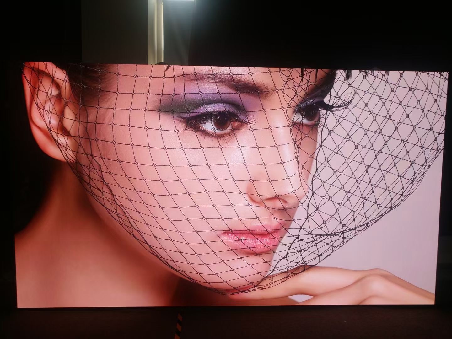 The LED video wall shows a picture of a beautiful woman.